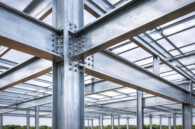 Steel frame structure protected with coating from metal building services to prevent rust.
